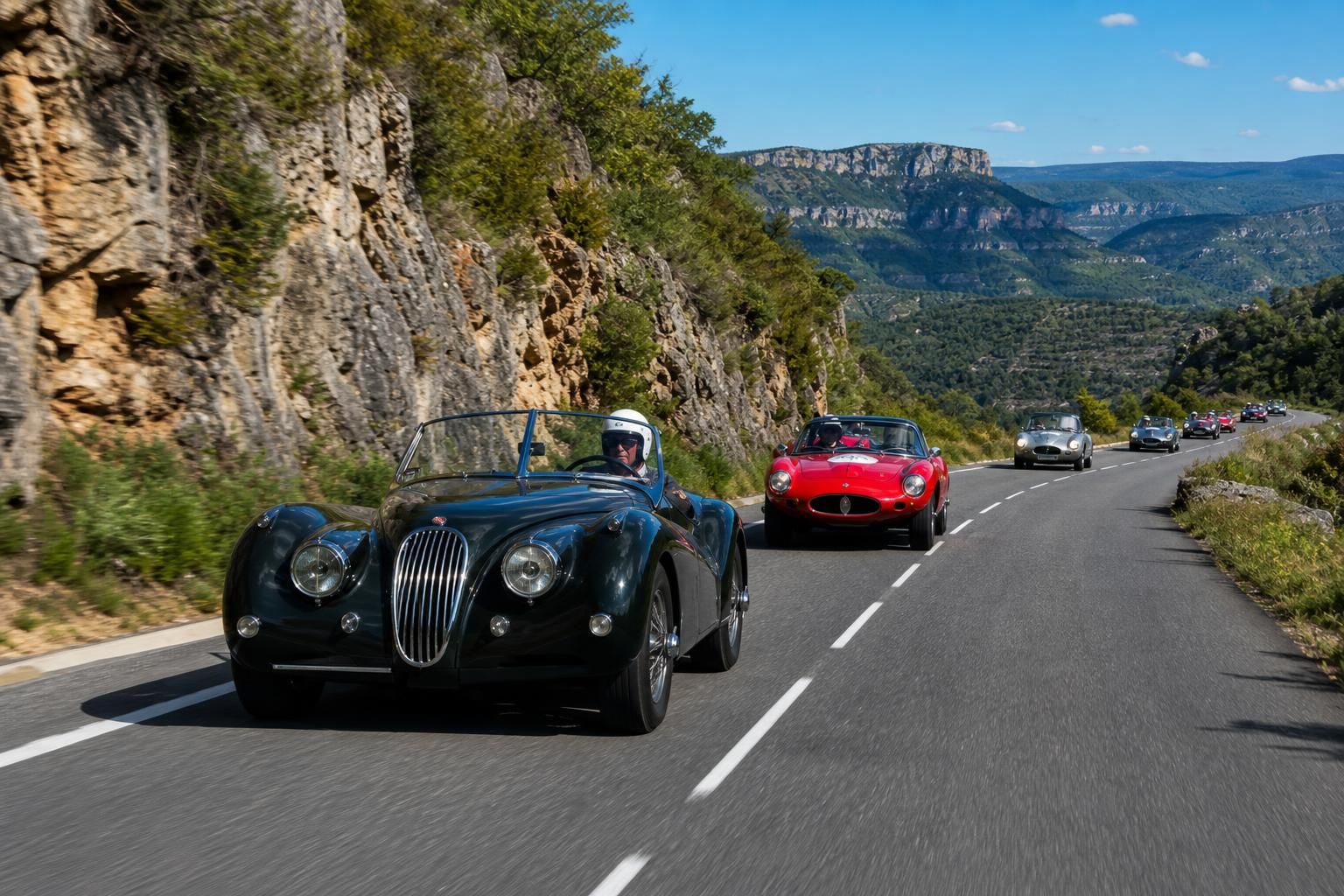 experience the tour auto 2026 as it cruises through lozère, showcasing a spectacular parade of iconic classic cars in a breathtaking scenic route.